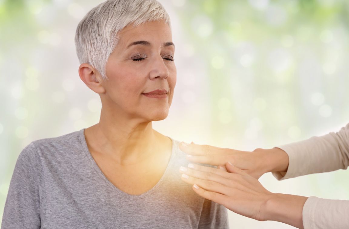 older woman being healed by holistic therapy